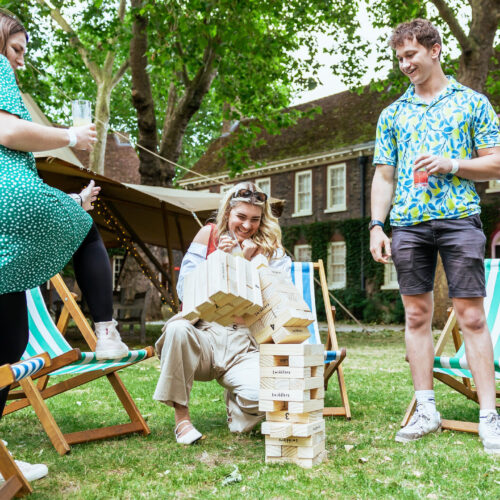 Guests playing giant Jenga outside in Shoreditch Gardens
