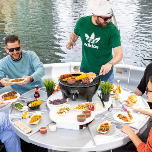 A group of friends enjoying a BBQ on the water in Canary Wharf with Skuna Boats