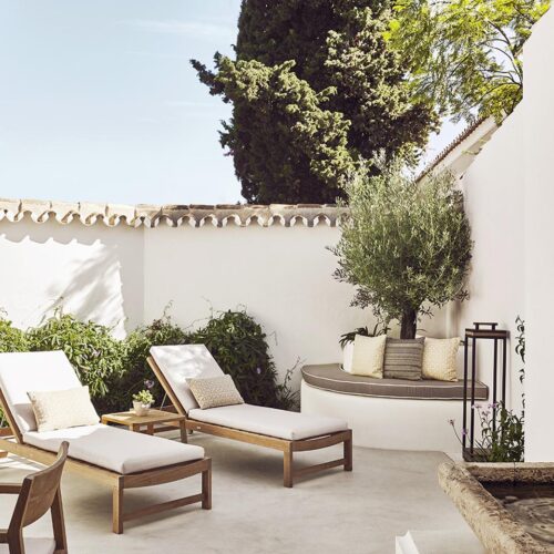 A private decking at Marbella Club Hotel, with comfortable deck chairs and greenert