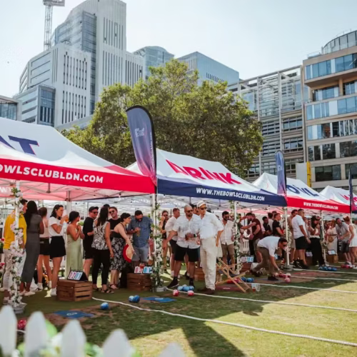 Guests lining up in the sun ready to play a game of Bowls at The Bowls Club in Finsbury Square
