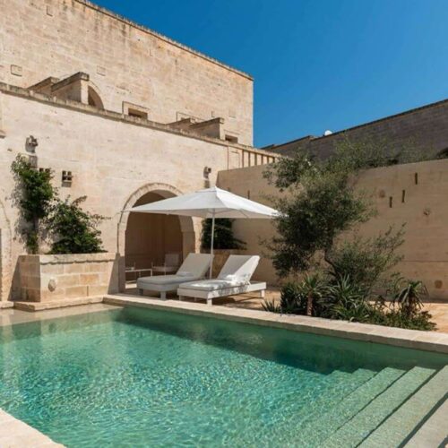 A private pool at Borgo Egnazia, surrounded by styling stone walls and greenery