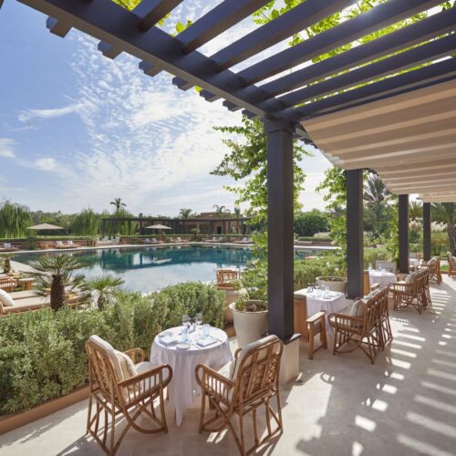 An outdoor seating area at Mandarin Oriental, which looks onto the pool