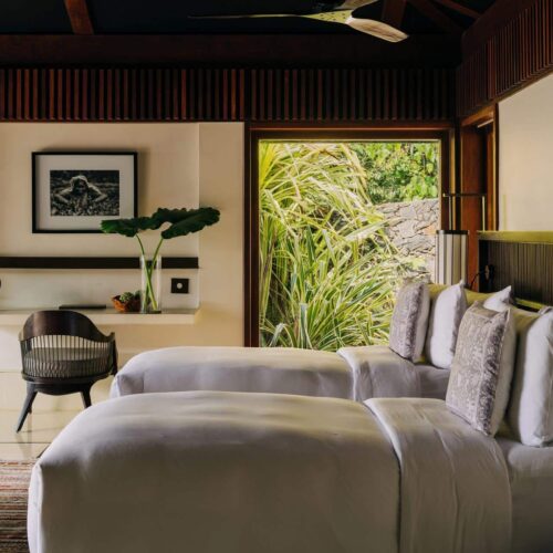 A twin room at ÀNI Sri Lanka, with views out onto the surrounding nature