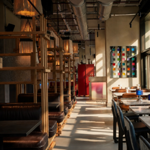 The indoor seating at Wolves of Tokyo, which has plenty of natural light and comfortable seating