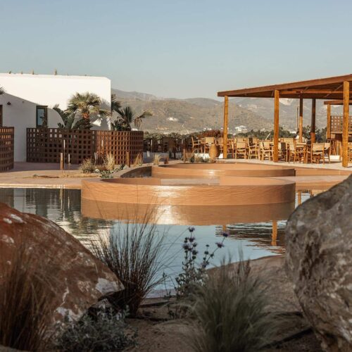 A view of the main pool at outdoor bar area in Laguna Coast Resort through some greenery