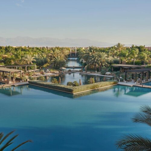 The view of the large pool area at Mandarin Oriental from above, surrounded by trees