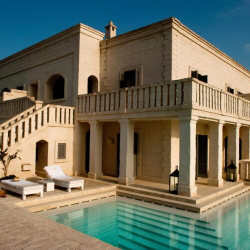 One of the villas at Borgo Egnazia, with a private pool, sun loungers, and terrace