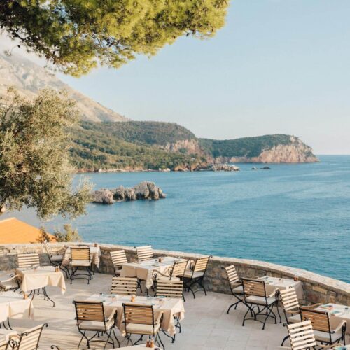An outside dining terrace at Aman Sveti Stefan, which directly overlooks the sea