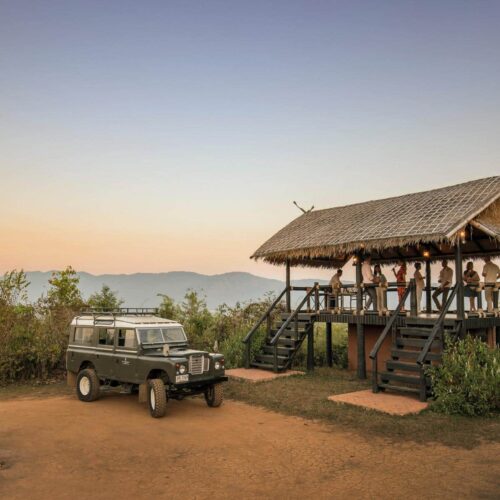 A jeep pulled up at Four Seasons Tented Camp Golden Triangle at sunset, for a safari experience