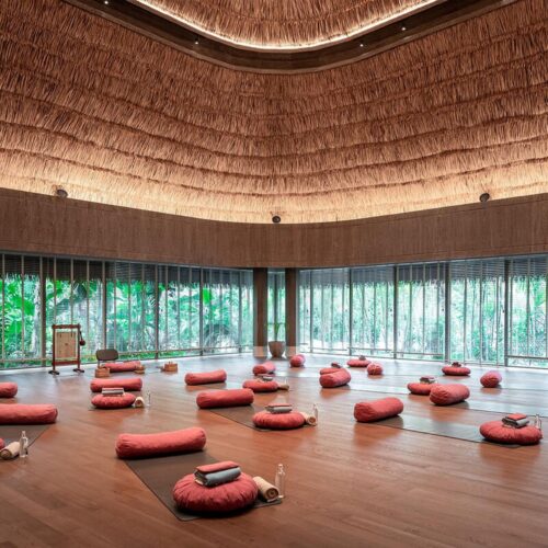 The large yoga and wellness space at JOALI BEING, which is surrounded by windows to help guests feel immersed in nature
