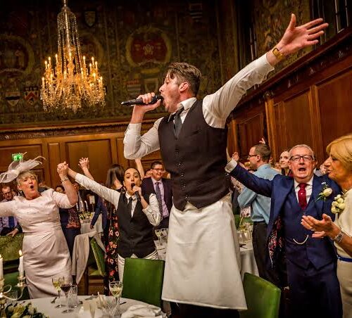 A surprise singing performance by a fake waiter at an event